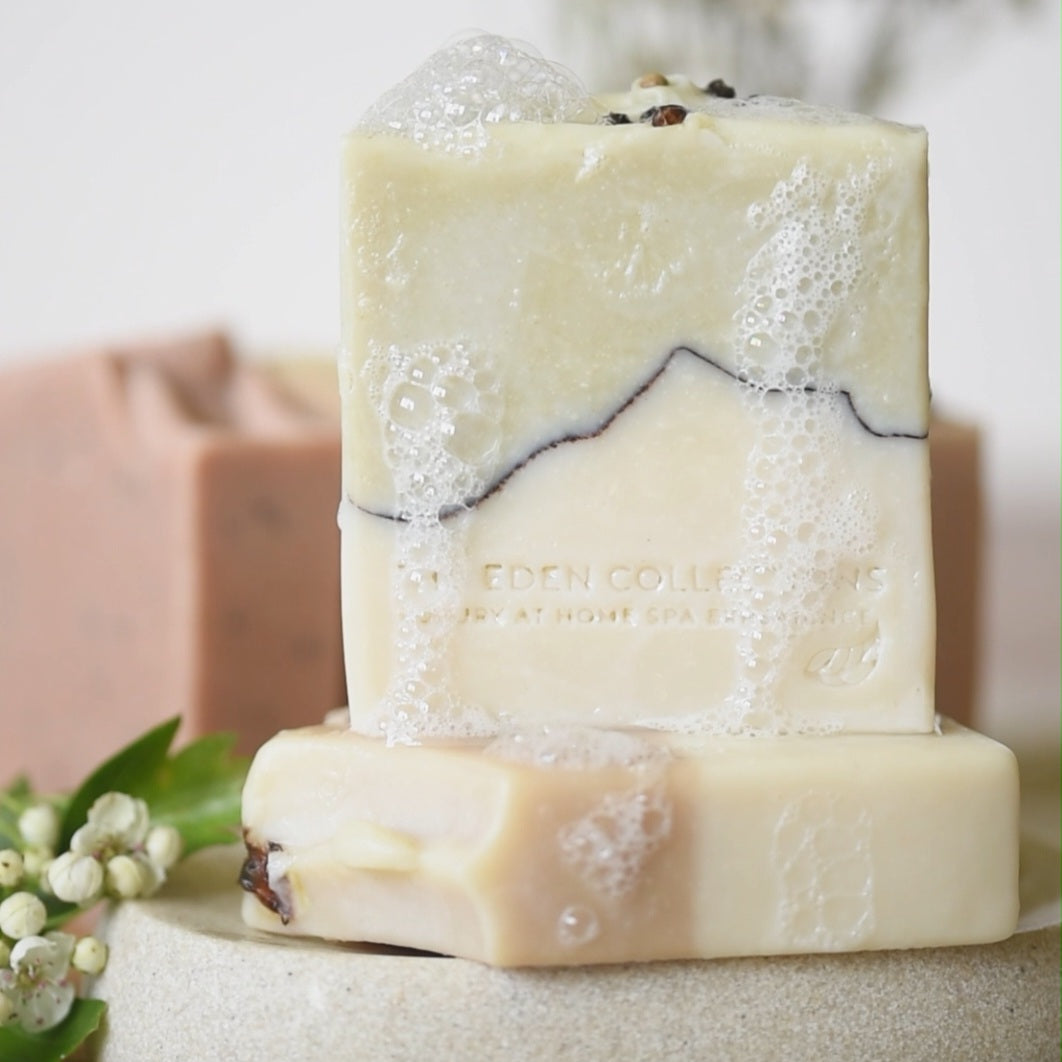 The Eden Collections rosemary and peppermint soap, showcased on a handmade ceramic plate with rich lather.