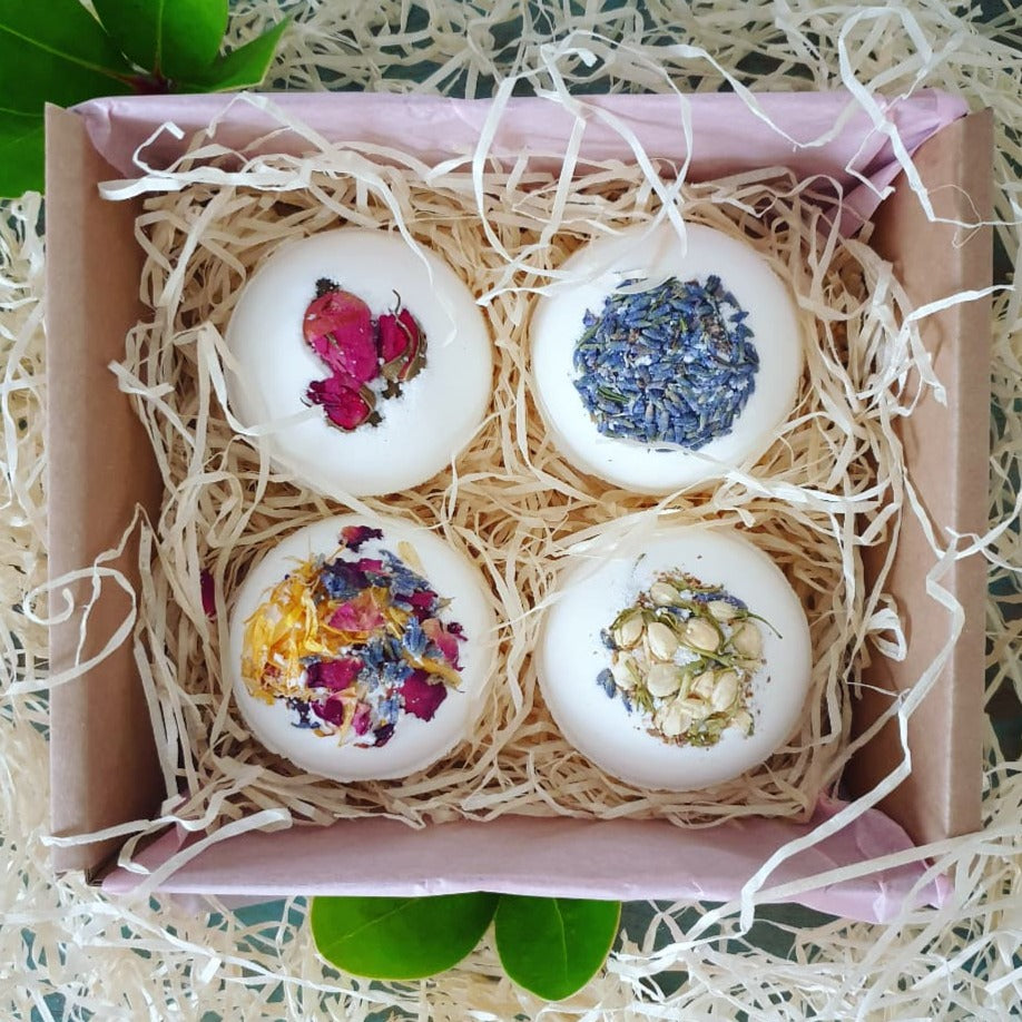 A photograph of The Eden Collections box of 4 Secret Bath Bombs, featuring Secret Bath Bombs in Lavender, Breathe, Rose, and Floral.