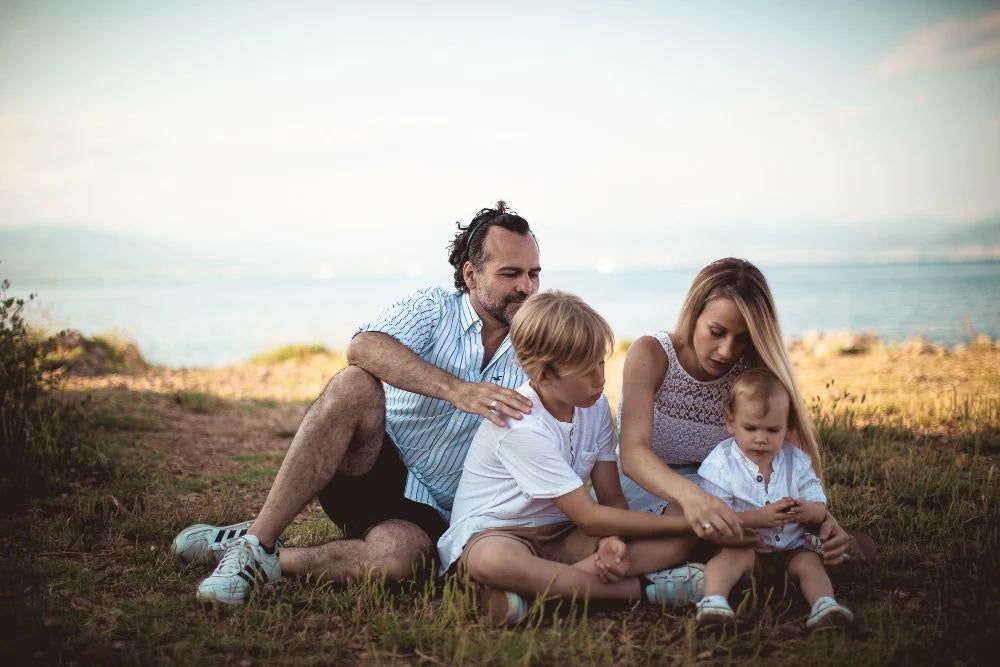 A family portrait taken on the cliff tops overlooking the sea, featuring the founders of The Eden Collections.