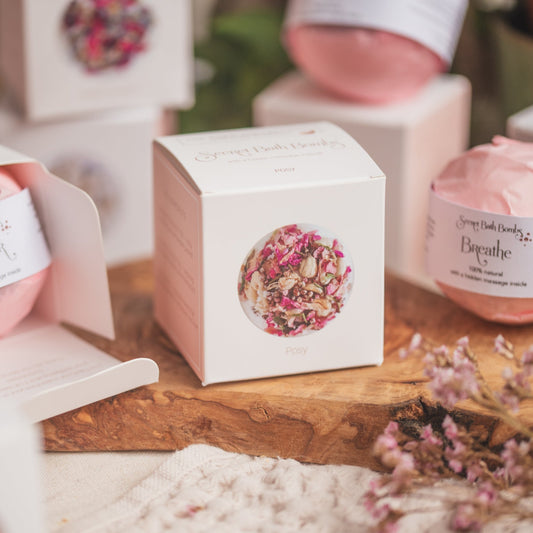 Individual Secret Bath Bomb boxes. Elegantly placed on a wooden board to showcase their aesthetic. Handmade by The Eden Collections