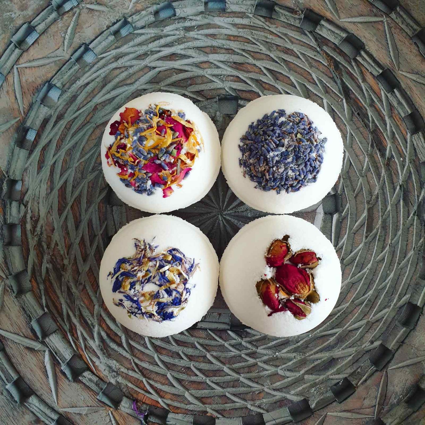 A photograph featuring the Eden Collections Secret Bath Bombs in Lavender, Breathe, Rose, and Floral.