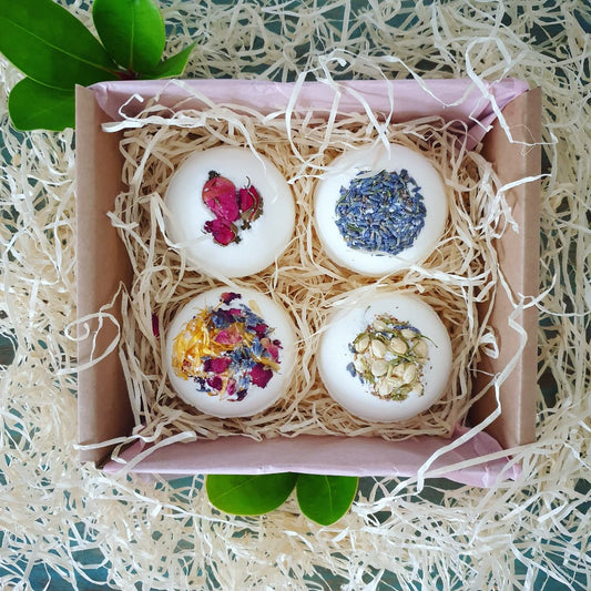 A photograph of The Eden Collections box of 4 Secret Bath Bombs, featuring Secret Bath Bombs in Lavender, Breathe, Rose, and Floral.