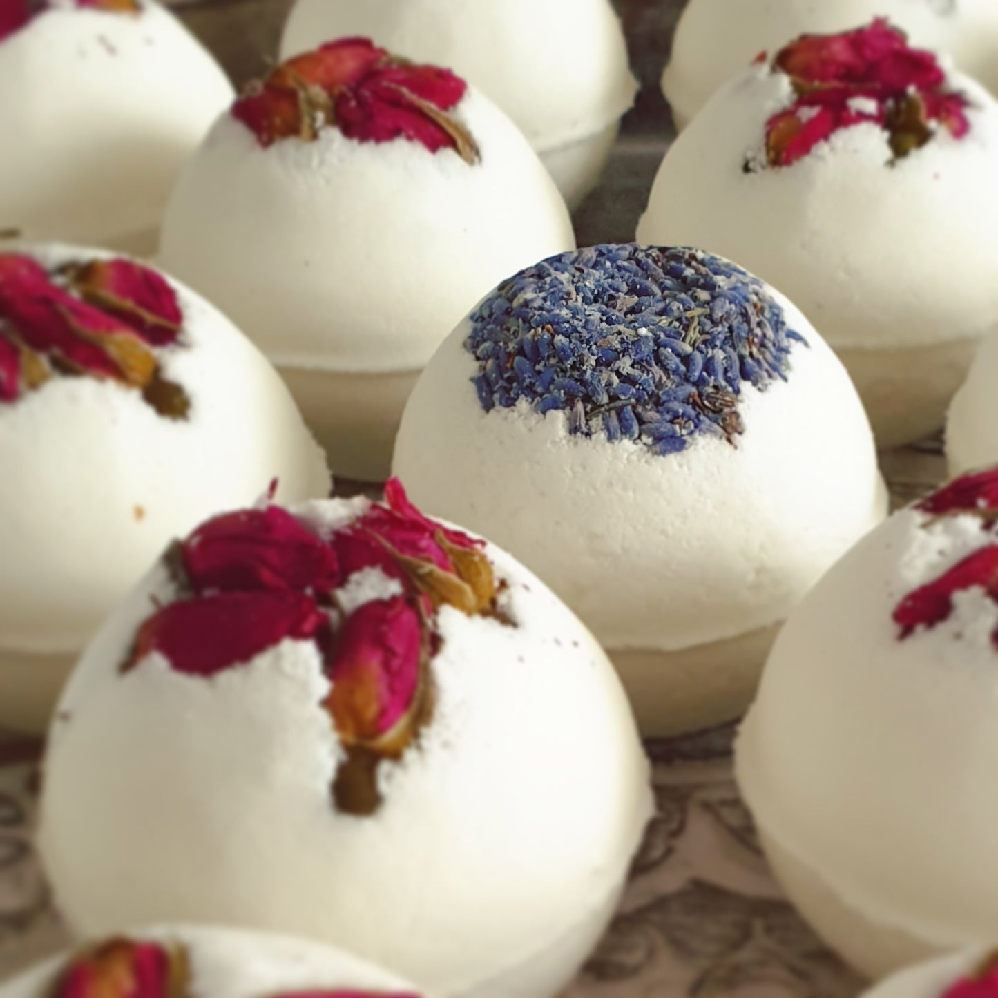 A range of The Eden Collections Secret Bath Bombs, including the Lavender and Rose Secret Bath Bombs. These natural bath bombs are made with organic butters and essential oils.