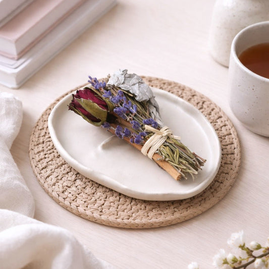 Ceramic tray with a botanical smudge, laying on a table.