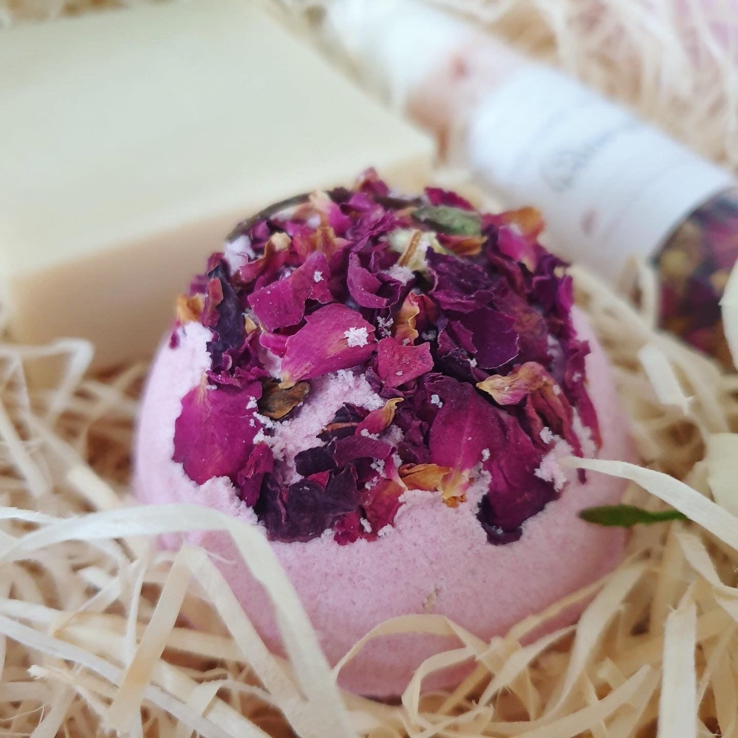 Anti-anxiety Secret Bath Bomb is laying on a wooden filing. This all natural bath bomb holds a positive hidden message inside and handmade by The Eden Collections.