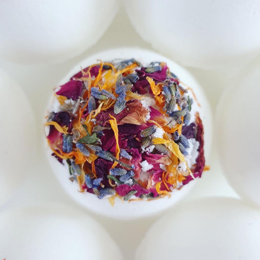 Floral Secret Bath Bomb has a sweet floral scent  thank you to the blend of geranium and ylang-ylang. Enriched with organic butters and handmade by The Eden Collections. It also hold a hidden message inside.