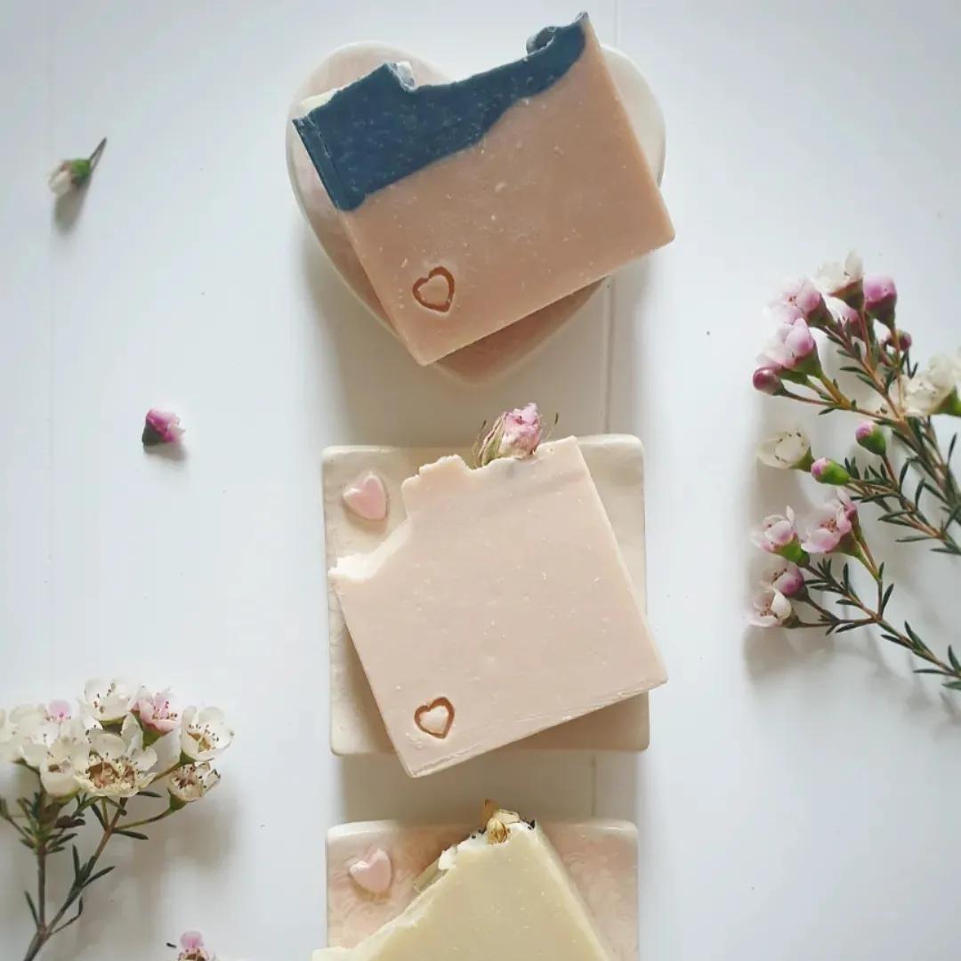 A range of The Eden Collections handmade artisan soap displayed on ceramic soap dishes handmade by The Eden Collections.
