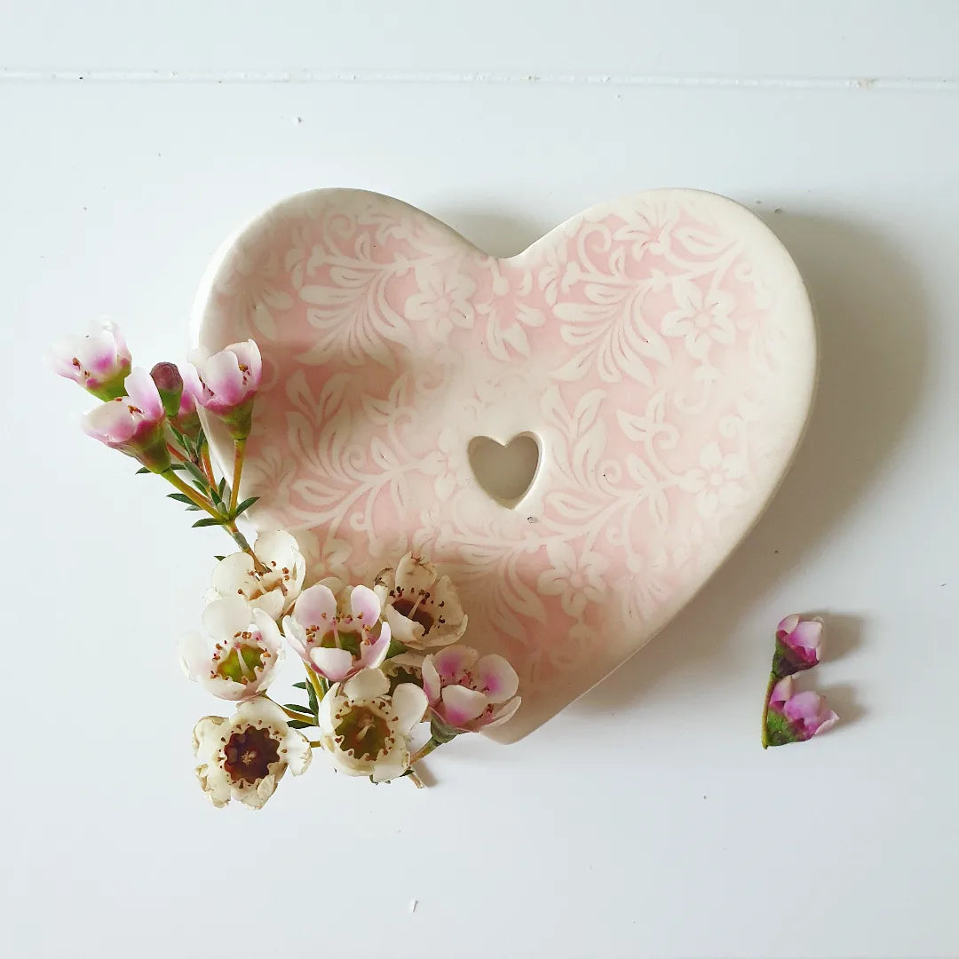 The Eden Collections handmade ceramic soap dish, heart shaped, showcased with cherry blossom.